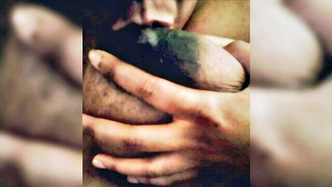 Close-up of hands fondling large breast with teasing lick in amateur porn video