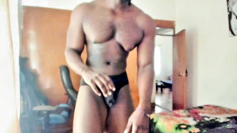 Muscular ebony man Joseph flexing in tight black underwear