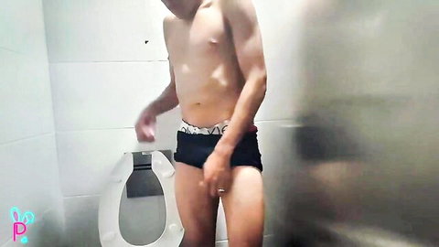 Muscular shirtless Asian hunk teases low Calvin Klein briefs bulge in bathroom by toilet