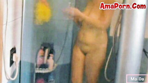Nude amateur babe soaping her big tits and shaved pussy behind steamy shower glass