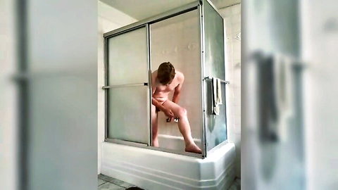 Naked muscular man squatting in foggy shower enclosure