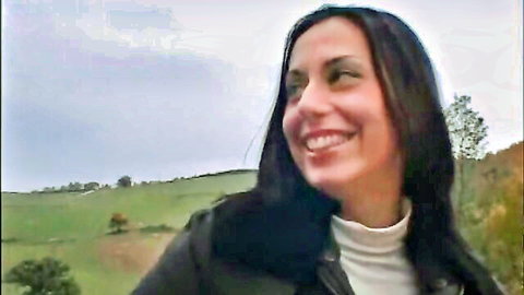 Erika Neri Italian MILF smiling outdoors in field, casual wear