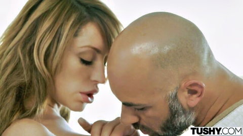 Blonde babe in intimate close-up kiss with bald hunk