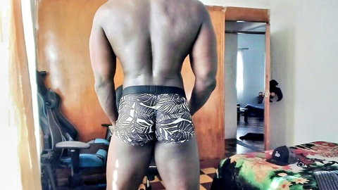 Muscular ebony hunk flexing his thick bubble butt in tight leaf print briefs from behind