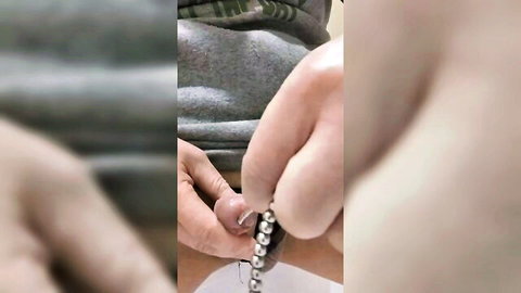 Blurry closeup of feminine hands inserting shiny silver anal beads into tight Asian trans asshole