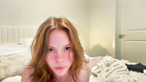Redhead webcam babe lies nude on bed exposing perky tits solo
