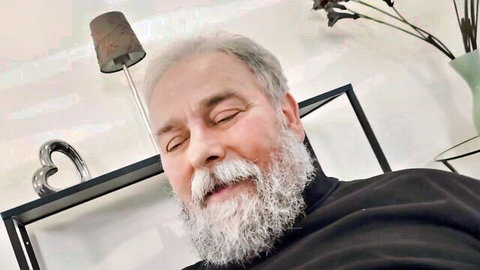 Bearded mature man with silver hair, eyes closed in bliss, featuring Caroline Mann