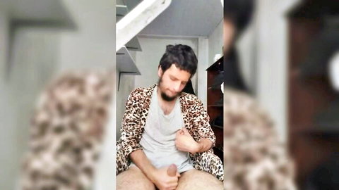 Tan-skinned stud in leopard robe stroking his big cock