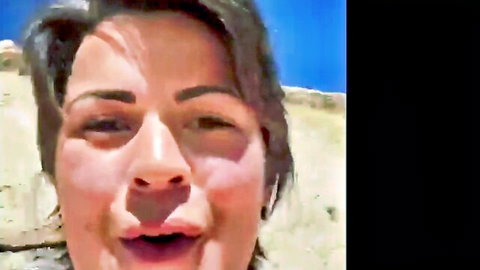 Brunette woman with open mouth and squinting eyes in sunny outdoor closeup