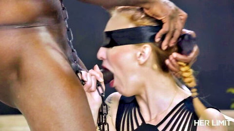 Blindfolded redhead in chains endures intense interracial oral sex