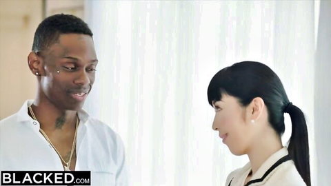 Petite Japanese woman faces black man intimately in white top and shirt