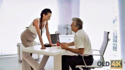 Brunette secretary bends over desk teasing old boss in office