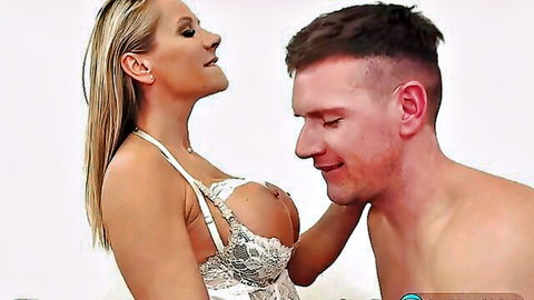 Blonde MILF with huge tits spilling from lace lingerie gropes muscular guy's face intimately