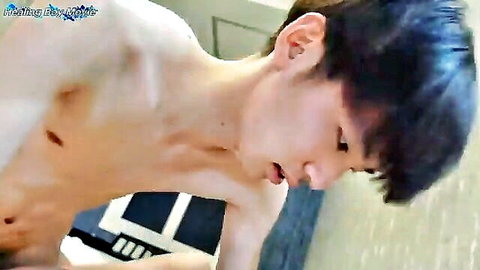 Shirtless young Asian twink leaning forward with mouth open in explicit pose