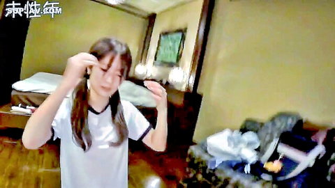 Cute Asian woman with pigtails in white shirt posing playfully