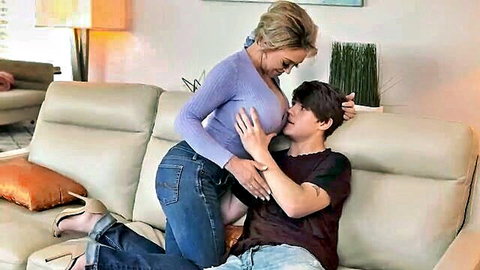 Dee Williams straddles son's friend intimately on couch in sweater and jeans
