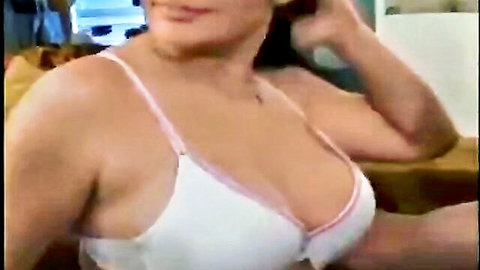 Curvy brunette with massive tits spilling from tight white bra with pink trim