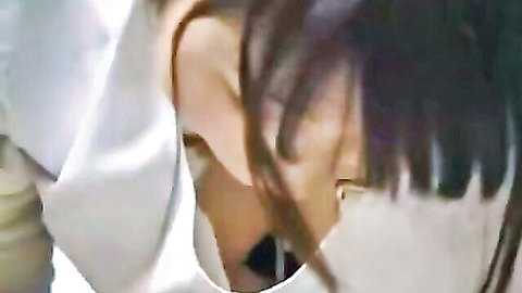 Close-up of Japanese massage therapist in white uniform, dark hair