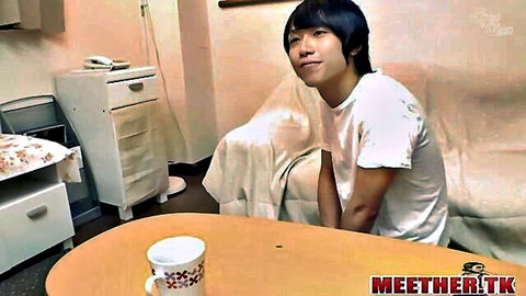 Young Japanese man smiling in white t-shirt, intimate home setup with mom-son vibe