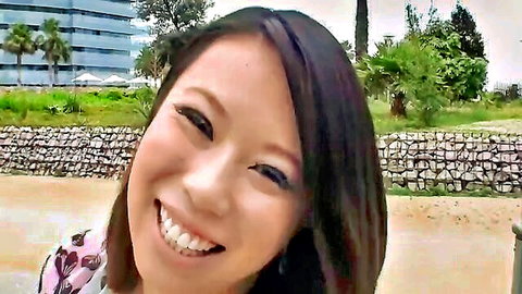 Smiling chubby Asian beauty in floral top outdoors