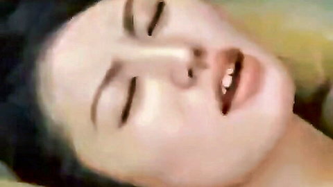 Close-up of ecstatic Korean woman with wet hair, eyes closed, mouth open in pleasure