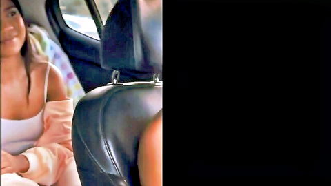 Sexy Asian babe smiling with deep cleavage in car backseat