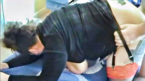 Mature woman's big bare ass exposed with red spanking marks and black garter straps during rough play