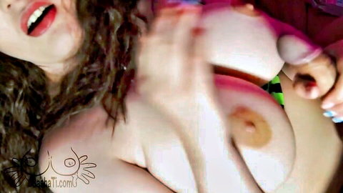 Curly-haired woman with big tits performs tittyfuck and handjob on thick cock