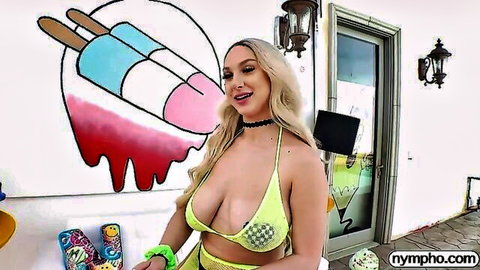 Busty blonde Skylar Vox in skimpy yellow bikini posing outdoors