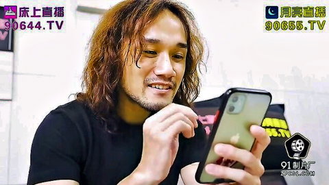 Asian man with long hair smiling at phone in black t-shirt, from big boobs wife hardcore sex video
