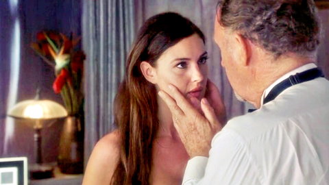 Monica Bellucci intimate face touch with older man in elegant scene