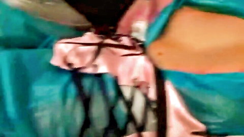 White model in shiny teal latex with pink ribbon bow over shaved pussy mound
