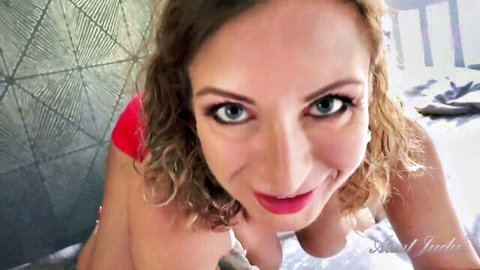 Julia North smiles seductively in close-up POV, red top teasing strip