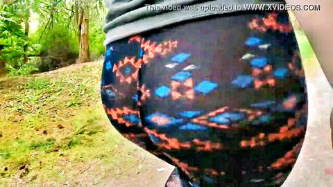 Curvy woman's massive ass in tight patterned leggings, public outdoor walk