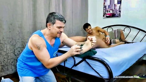 Muscular Asian man tickled on feet by older guy in gay fetish scene