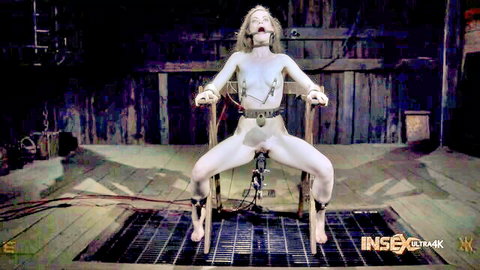 Naked blonde BDSM slave gagged bound to chair legs spread pussy on fucking machine dildo