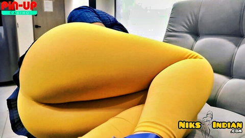 Thick Indian MILF's massive big ass in tight yellow leggings bulging on gray couch close-up