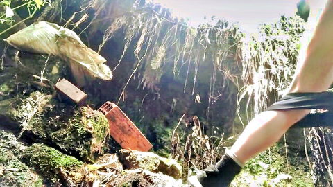 POV closeup of woman pulling black panties aside exposing shaved pussy outdoors on rocks