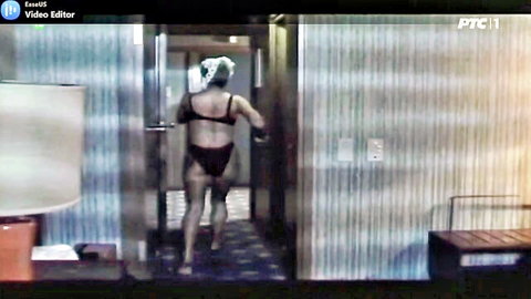 Brunette in black bra and thong walks down hotel hallway showing bare juicy ass cheeks