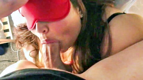 Blindfolded brunette in lingerie giving deep blowjob to man