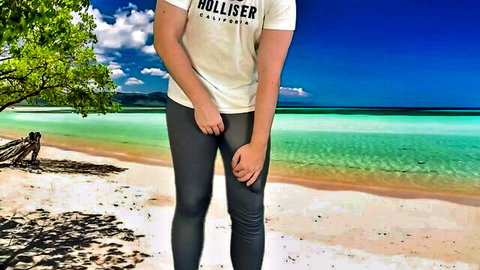 Guy in Hollister shirt and tight black pants teases bulge on sunny beach