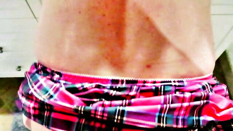Heather Riggs in lifted pink plaid skirt revealing white panties from behind