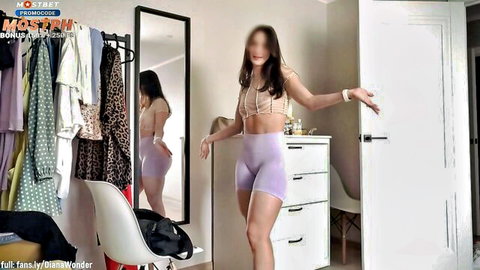 Fit brunette in crop top and tight purple shorts posing seductively