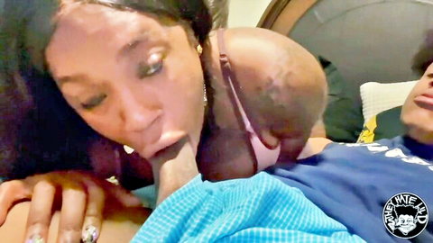 Curvy ebony babe with long hair sucking massive BBC while young black stud watches