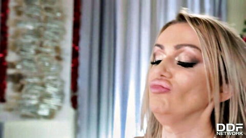 Blonde beauty pouting seductively in festive lesbian Christmas scene