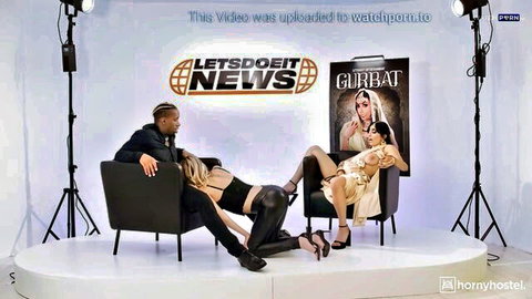 Blonde slut legs spread over black stud's lap with Asian babe in sexy news studio threesome tease