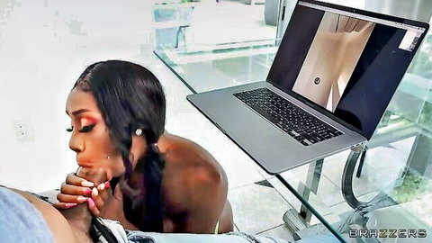 Ebony babe with big tits leans over laptop to deepthroat thick cock on glass table