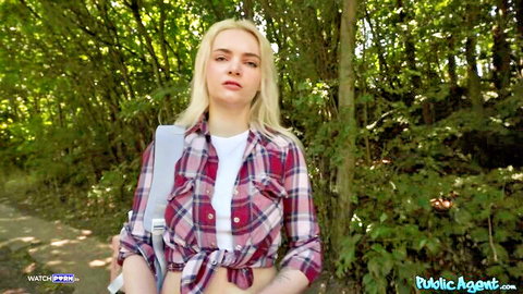 Blonde babe with medium natural tits flashing deep cleavage in tied plaid shirt on forest path