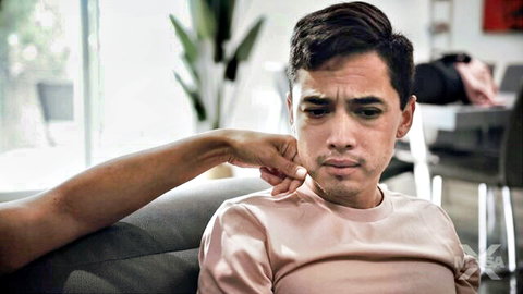 Penny Barber teasing young man by pinching his cheek