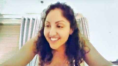 Smiling Arab MILF with curly hair and cleavage in homemade amateur porn